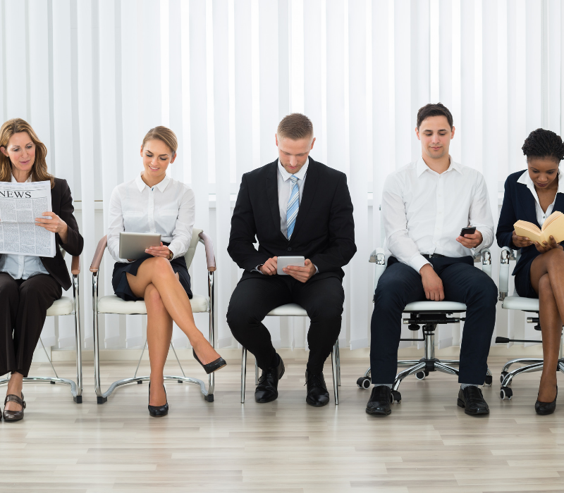 Interview Skills GUide. Candidates sitting ina waiting room waiting for an interview.